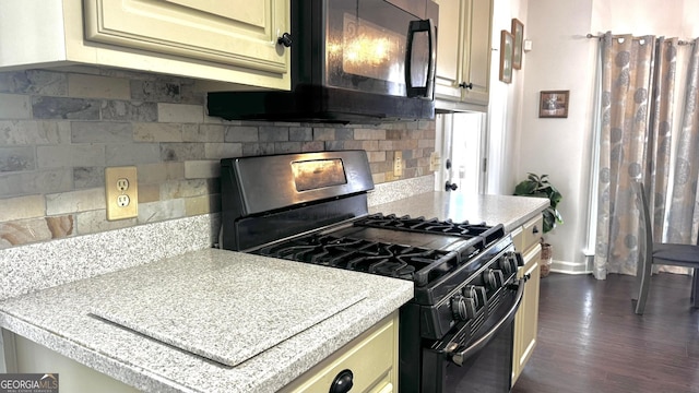 kitchen with tasteful backsplash, range with gas cooktop, black microwave, light countertops, and dark wood-style flooring