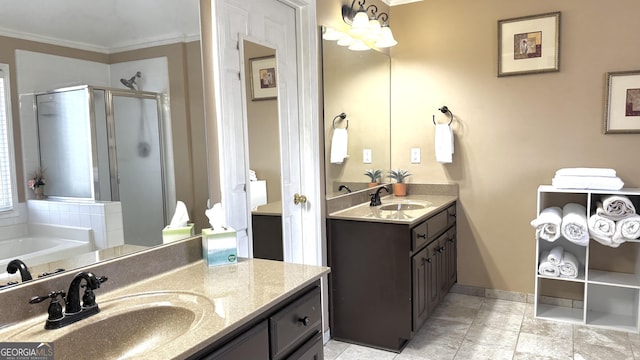 full bath with ornamental molding, a stall shower, two vanities, and a sink