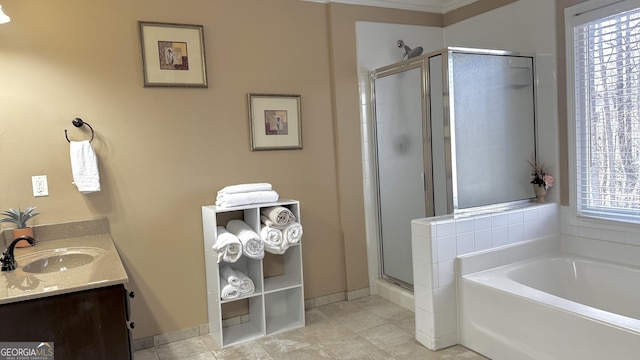 bathroom featuring tile patterned flooring, a shower stall, baseboards, a garden tub, and vanity