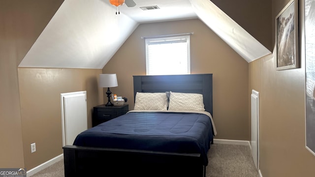 carpeted bedroom with visible vents, ceiling fan, baseboards, and vaulted ceiling