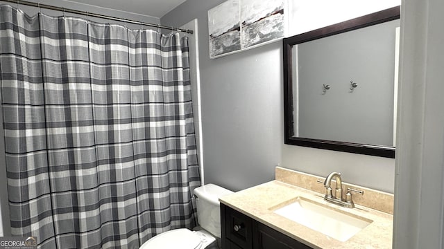 bathroom featuring vanity, a shower with shower curtain, and toilet