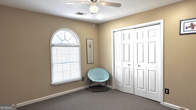 interior space with visible vents, carpet flooring, baseboards, and a ceiling fan