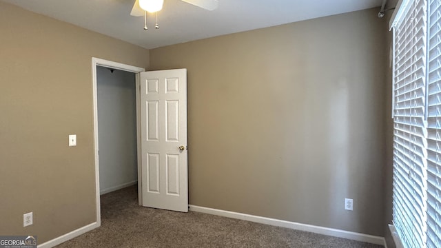 unfurnished bedroom featuring carpet flooring, a ceiling fan, and baseboards