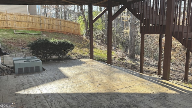 view of patio with central AC and fence