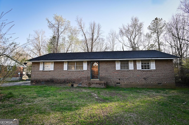 view of front of house with crawl space, brick siding, and a front yard