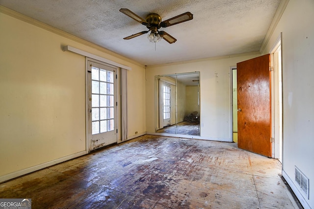 spare room with a textured ceiling, ceiling fan, and crown molding