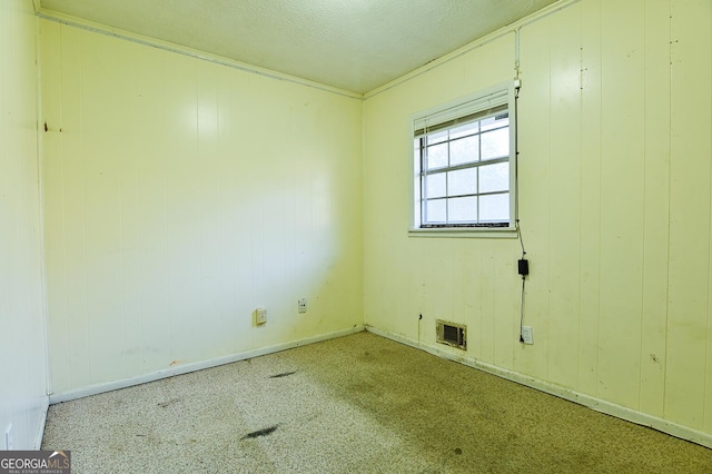 empty room featuring visible vents and a textured ceiling