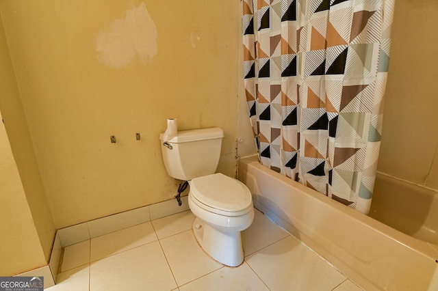 bathroom with tile patterned flooring, shower / tub combo, and toilet