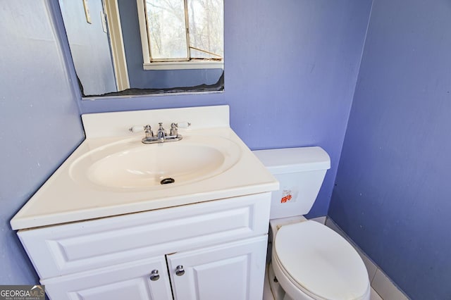 half bath featuring toilet and vanity