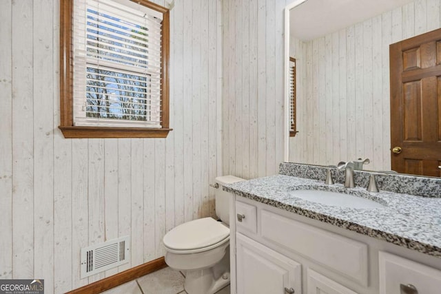 bathroom with tile patterned floors, visible vents, toilet, and vanity