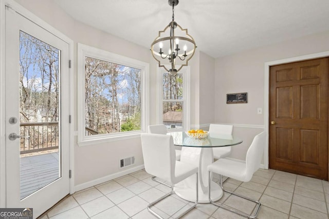 dining room with visible vents, baseboards, a chandelier, and light tile patterned flooring