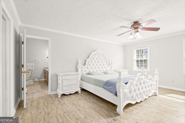 bedroom featuring light wood finished floors, a textured ceiling, crown molding, and baseboards