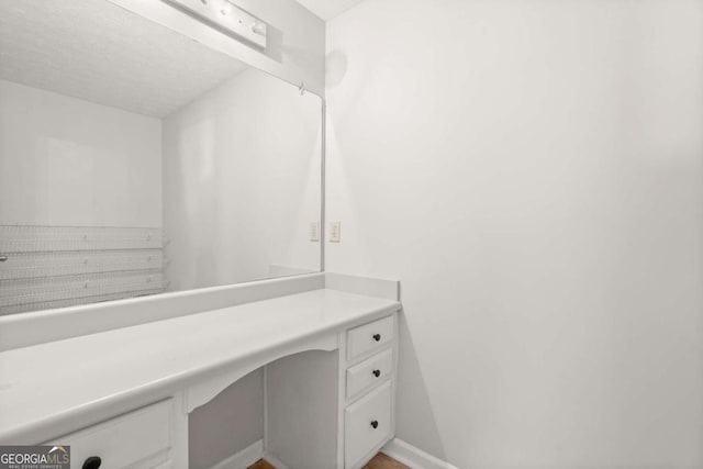 bathroom with vanity and baseboards