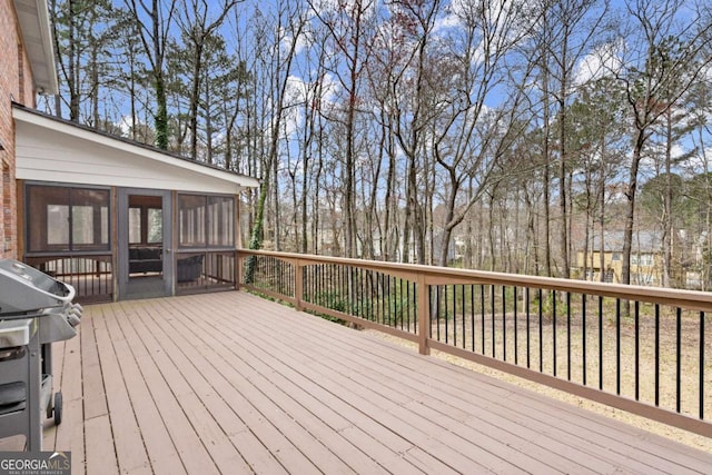 wooden terrace featuring grilling area and a sunroom