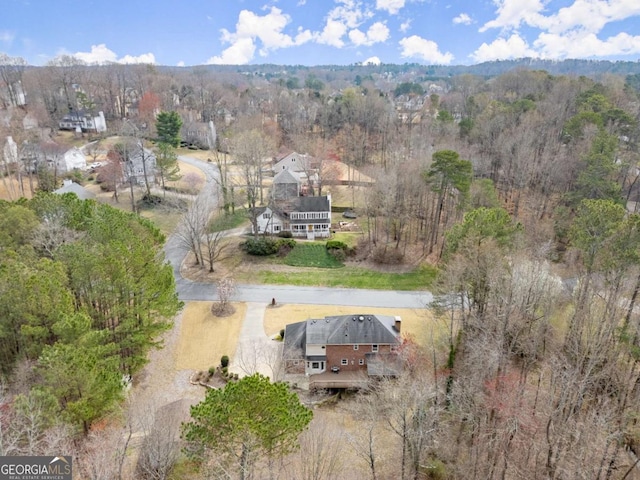 bird's eye view featuring a wooded view