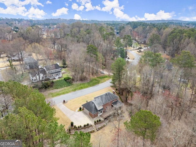 birds eye view of property featuring a wooded view