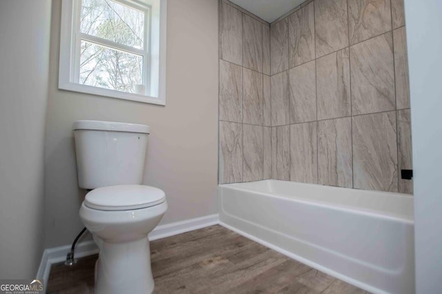 full bathroom with toilet, baseboards, and wood finished floors