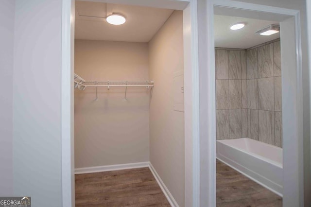 walk in closet featuring wood finished floors