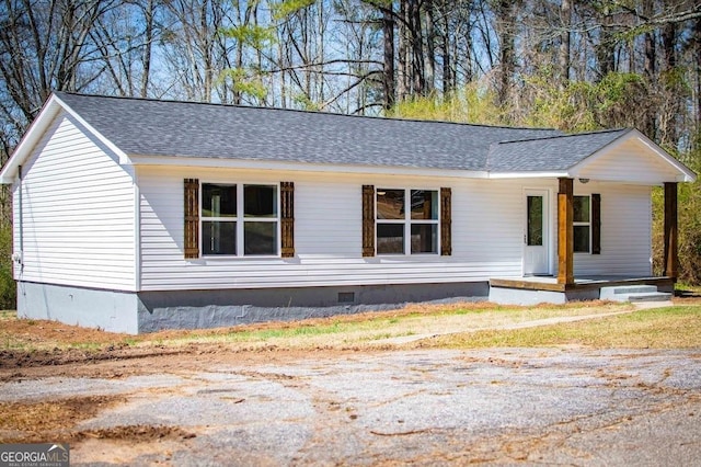 view of front of home featuring covered porch, roof with shingles, and crawl space