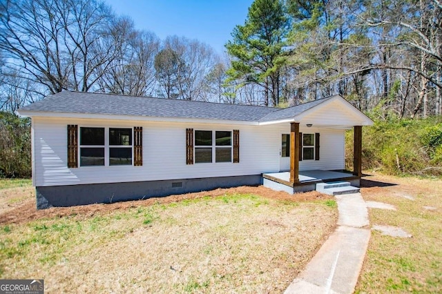 view of front of home with crawl space, a front lawn, covered porch, and a shingled roof