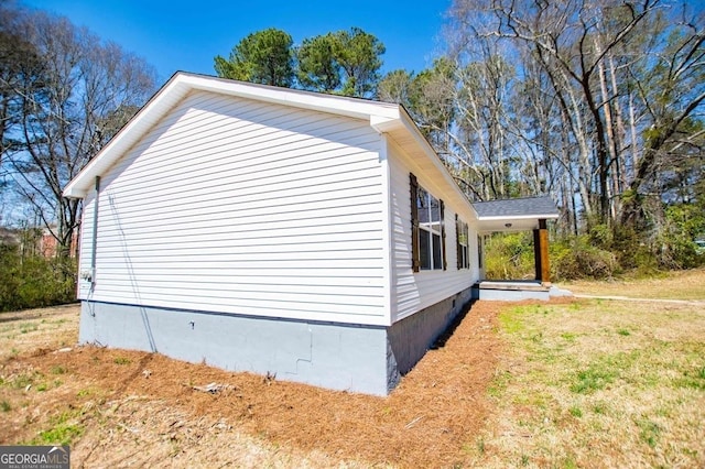 view of side of home featuring a lawn