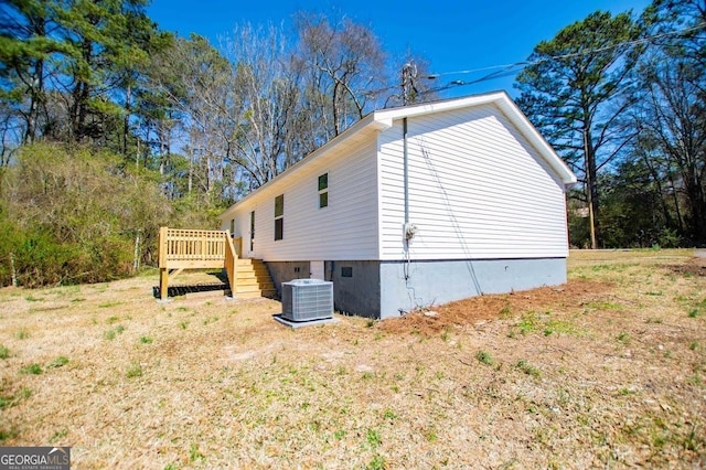 view of side of home with stairway, cooling unit, and a wooden deck