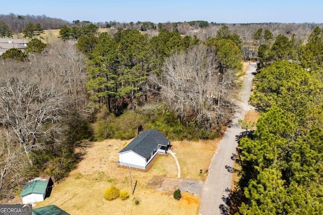 bird's eye view featuring a wooded view