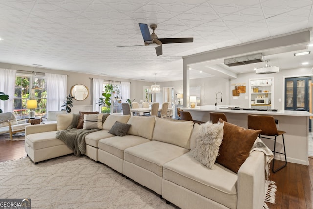 living room featuring a ceiling fan and wood finished floors