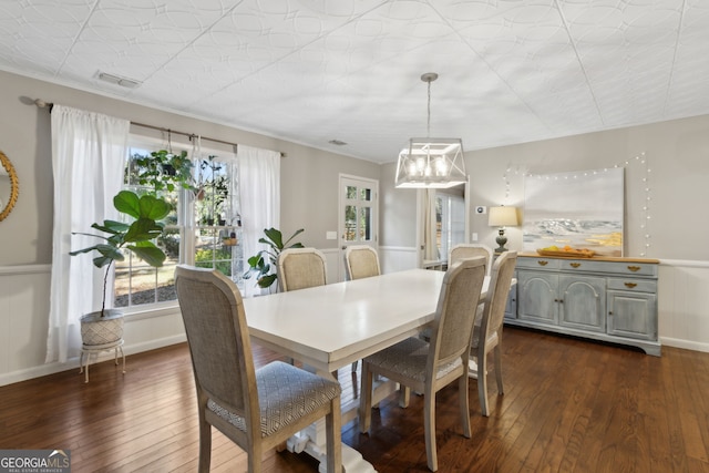 dining space featuring visible vents, baseboards, and dark wood finished floors