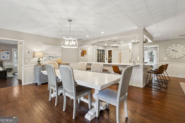 dining room featuring dark wood finished floors, recessed lighting, and baseboards