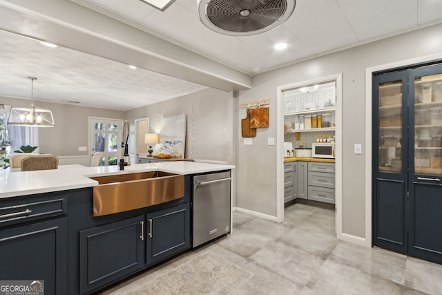 kitchen featuring white microwave, an inviting chandelier, a sink, light countertops, and stainless steel dishwasher