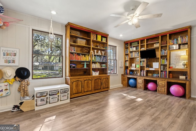 exercise room featuring a ceiling fan and wood finished floors