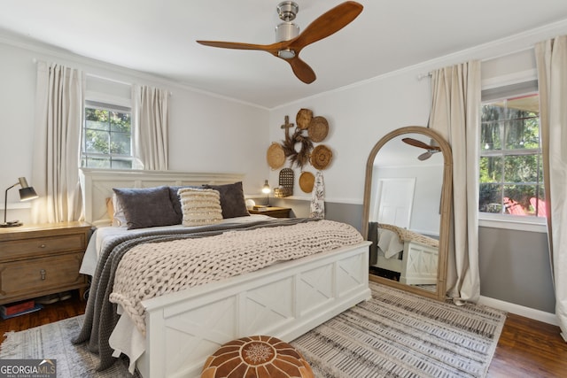 bedroom featuring a ceiling fan, wood finished floors, baseboards, and ornamental molding