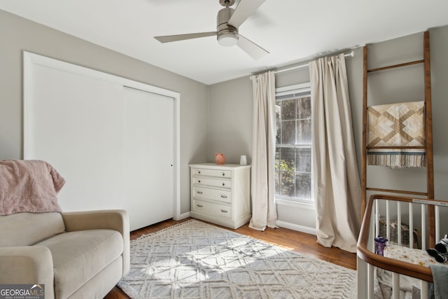 sitting room featuring wood finished floors, a ceiling fan, and baseboards