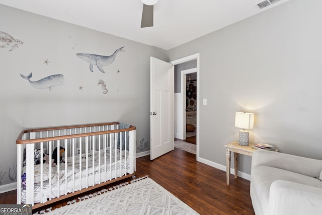 bedroom featuring baseboards, wood finished floors, and a ceiling fan