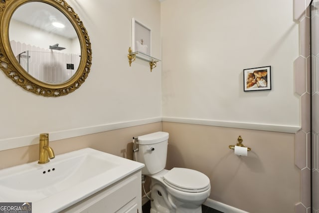 bathroom featuring toilet and vanity