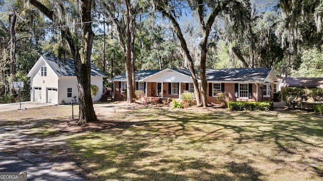 ranch-style home featuring a front yard, a garage, brick siding, and driveway