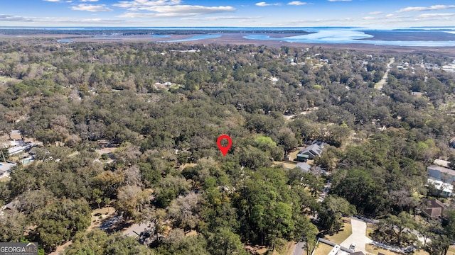 drone / aerial view featuring a forest view