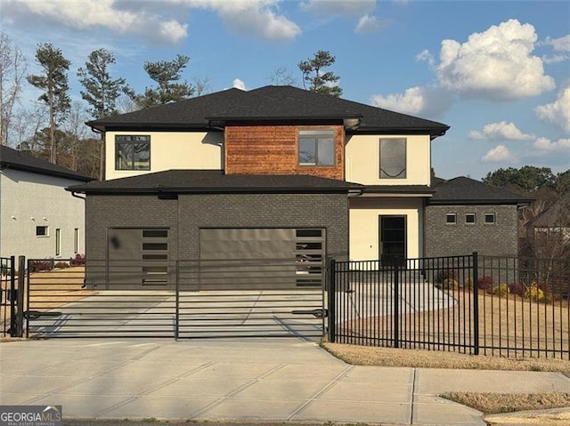 view of front of house featuring brick siding, concrete driveway, and fence