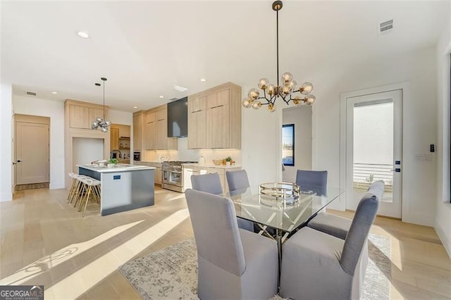 dining space featuring a chandelier, visible vents, recessed lighting, and light wood-style flooring