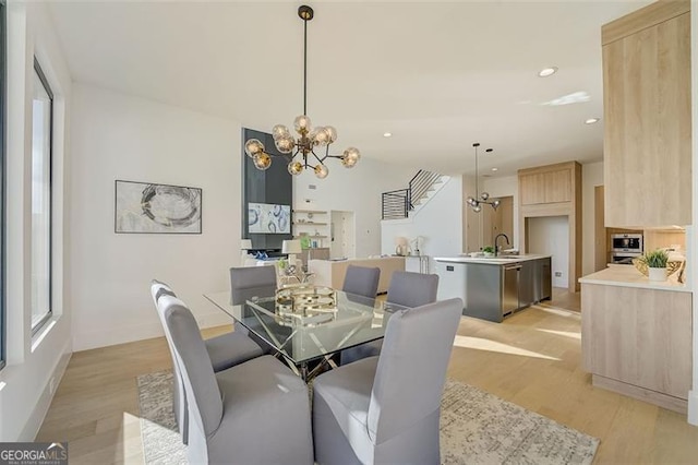 dining space with a notable chandelier, recessed lighting, light wood finished floors, and a healthy amount of sunlight