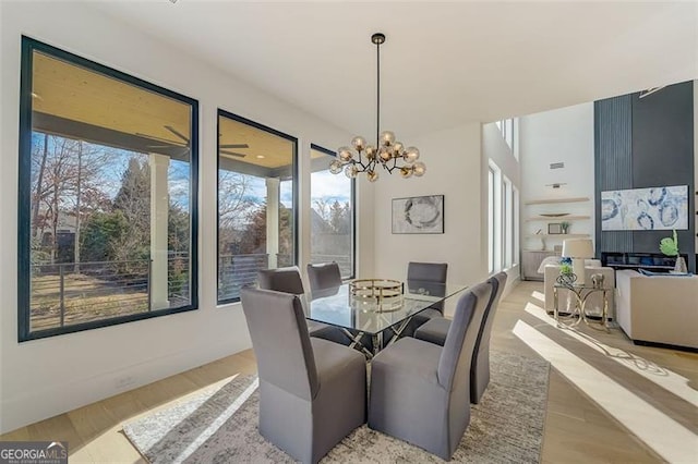 dining room featuring light wood finished floors and an inviting chandelier