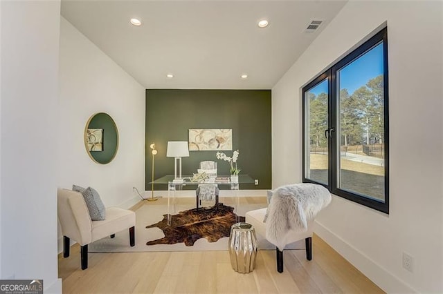 sitting room with visible vents, recessed lighting, baseboards, and wood finished floors