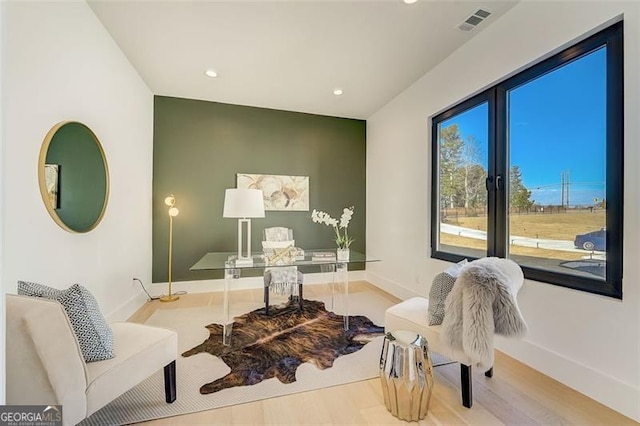 living area featuring wood finished floors, recessed lighting, baseboards, and visible vents