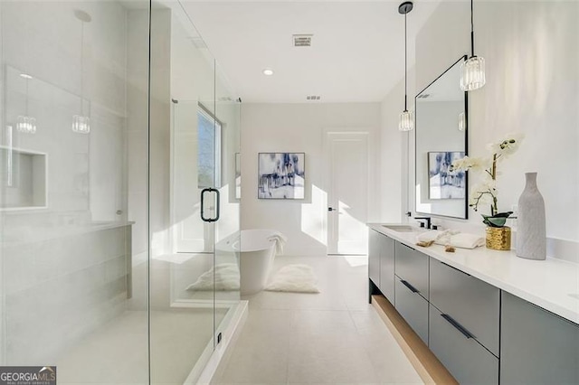 full bath featuring visible vents, a stall shower, recessed lighting, double vanity, and a soaking tub