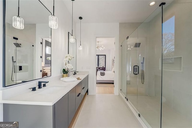 ensuite bathroom with ensuite bath, a stall shower, and a chandelier