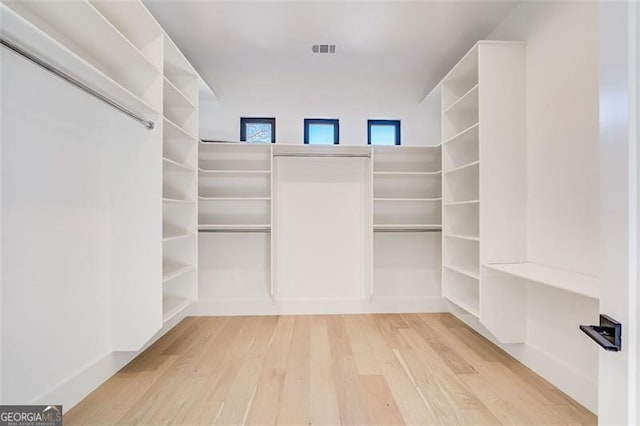 spacious closet with visible vents and wood finished floors