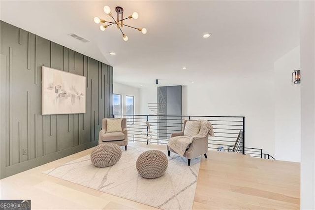 sitting room with recessed lighting, an upstairs landing, visible vents, and a chandelier