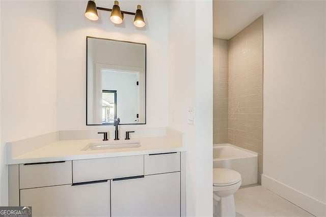 bathroom with vanity, baseboards,  shower combination, tile patterned floors, and toilet