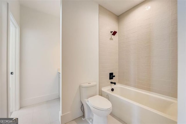 bathroom with tile patterned flooring, toilet, baseboards, and shower / washtub combination